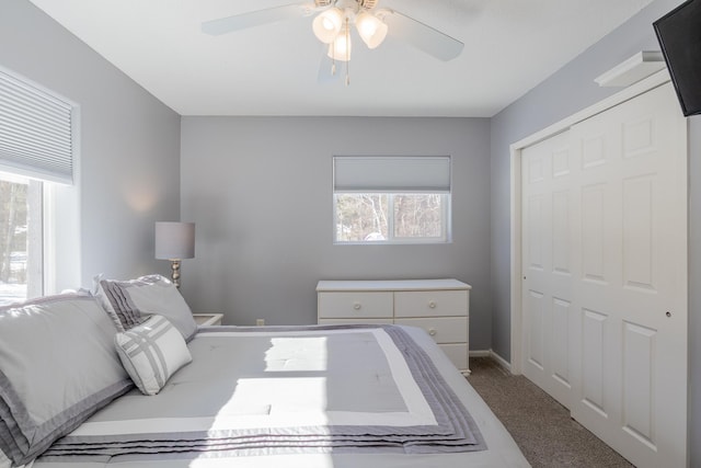 bedroom with ceiling fan, carpet floors, a closet, and baseboards