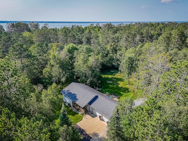 birds eye view of property featuring a water view and a forest view