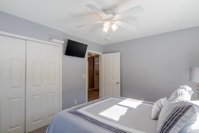 bedroom with a ceiling fan and a closet