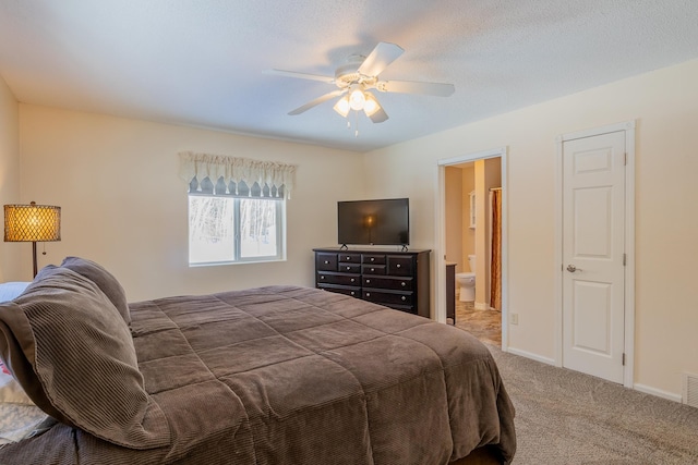 bedroom featuring visible vents, carpet flooring, connected bathroom, ceiling fan, and baseboards