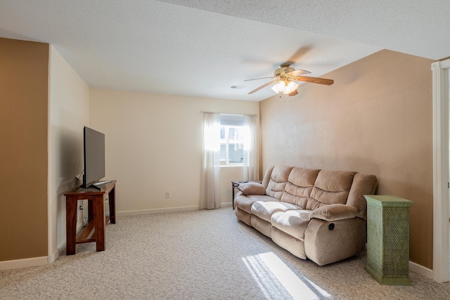 living area featuring light carpet, ceiling fan, and baseboards