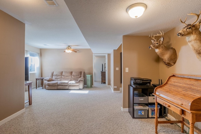 interior space with baseboards, a textured ceiling, visible vents, and carpet flooring