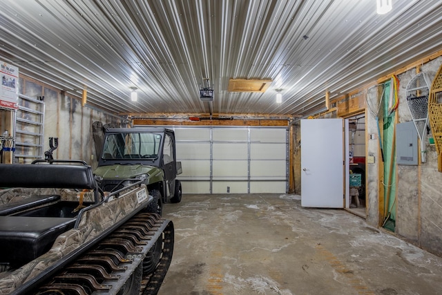 garage with electric panel and a garage door opener