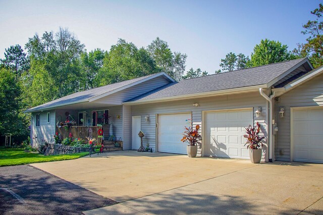 2955 Saint Onge Dr NE, Bemidji, MN 56601 - single story home with a garage, a porch, driveway, and roof with shingles