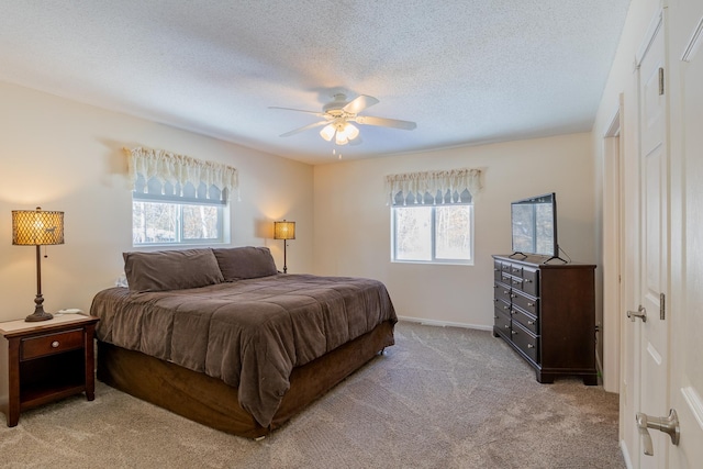 2955 Saint Onge Dr NE, Bemidji, MN 56601 - bedroom with light colored carpet, ceiling fan, a textured ceiling, and baseboards