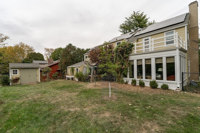 view of yard featuring fence, a storage unit, and an outdoor structure