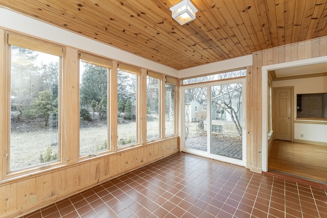 unfurnished sunroom featuring wood ceiling