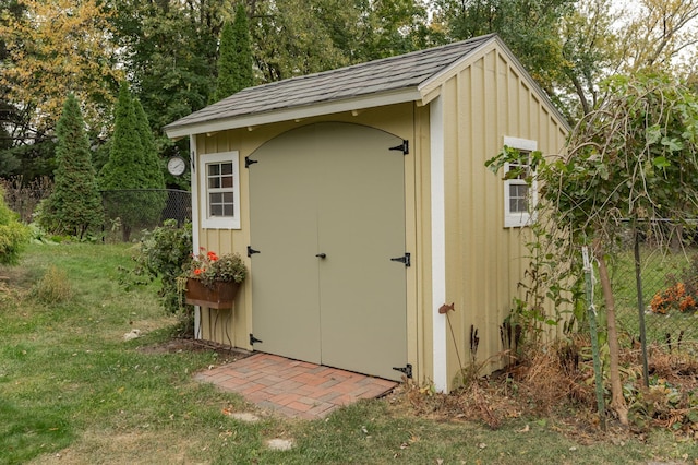 view of shed featuring fence