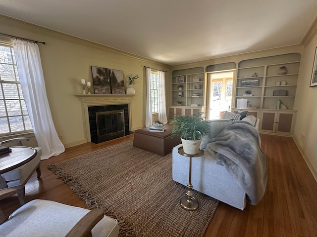 1130 6th St SW, Rochester, MN 55902 - living room with ornamental molding, wood finished floors, healthy amount of natural light, a tile fireplace, and baseboards
