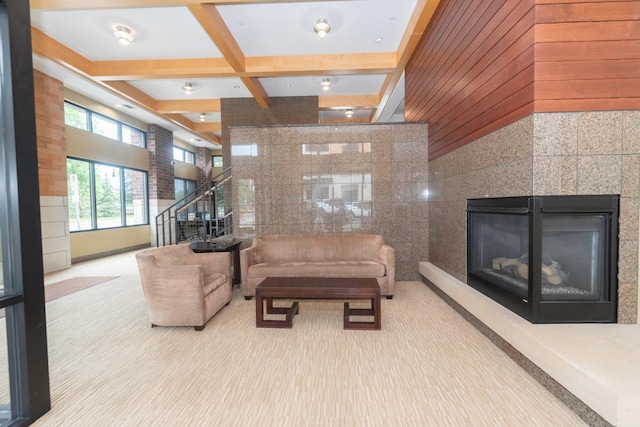 living room featuring coffered ceiling, light carpet, and beamed ceiling