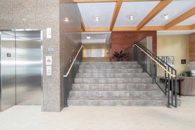 stairway featuring elevator and beam ceiling