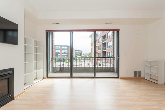 unfurnished living room with light hardwood / wood-style flooring