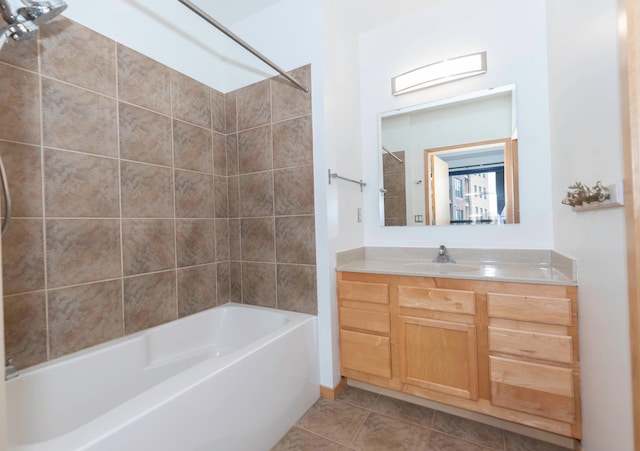 bathroom with tile patterned floors, tiled shower / bath combo, and vanity