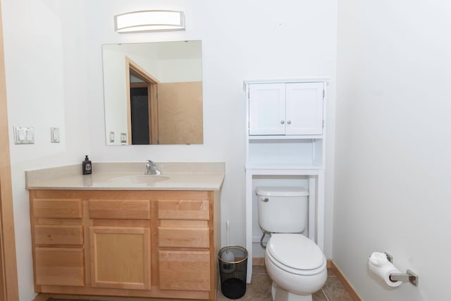 bathroom featuring vanity, tile patterned floors, and toilet