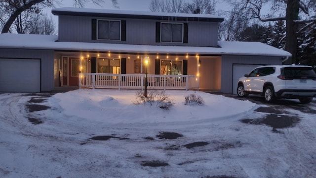 view of front of home featuring covered porch and an attached garage