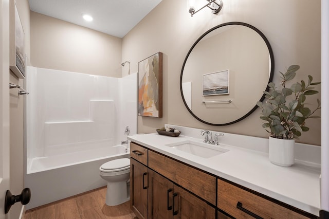 full bathroom featuring hardwood / wood-style flooring, shower / tub combination, vanity, and toilet