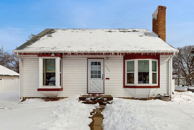 view of front of property featuring fence and a chimney