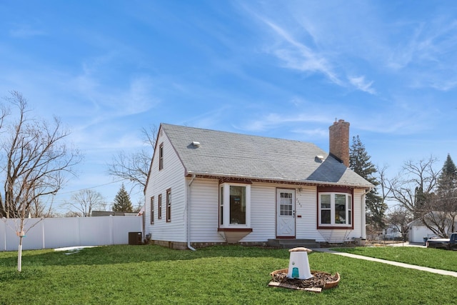 view of front of home with central air condition unit, a chimney, a front lawn, and fence