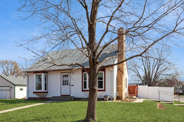 view of front of house featuring a front lawn, fence, central AC, and a chimney