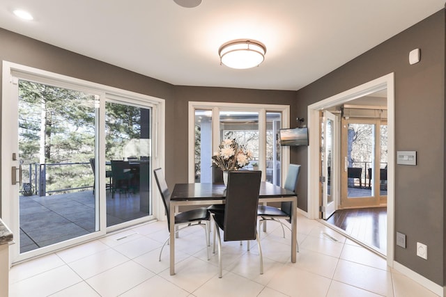 dining room with light tile patterned flooring and baseboards