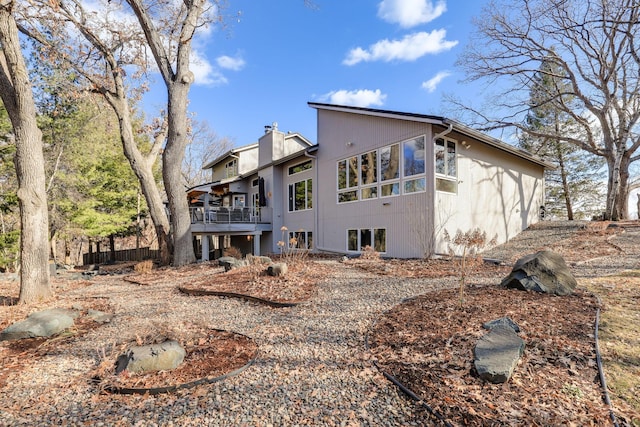 rear view of property with a chimney