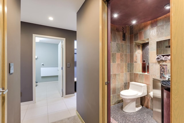 bathroom with tile walls, recessed lighting, toilet, baseboards, and tile patterned floors