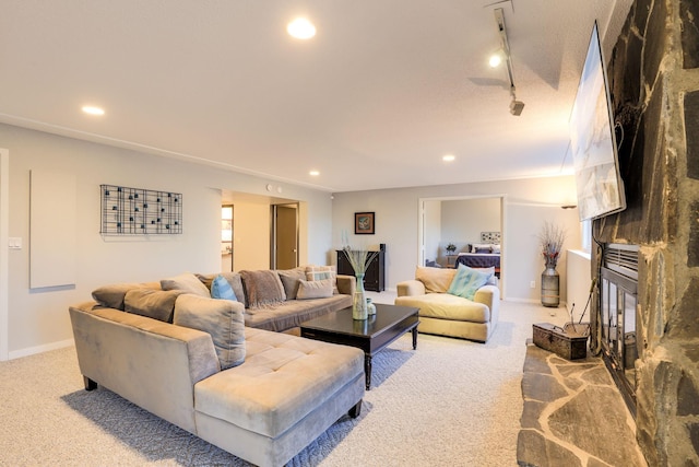 living area featuring rail lighting, carpet, a fireplace, and recessed lighting