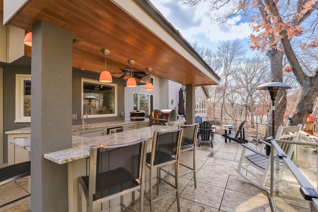 view of patio / terrace with ceiling fan, outdoor wet bar, grilling area, and area for grilling