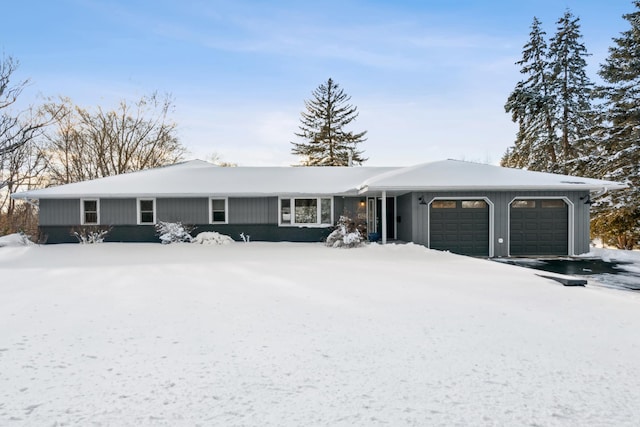 ranch-style house featuring a garage and driveway