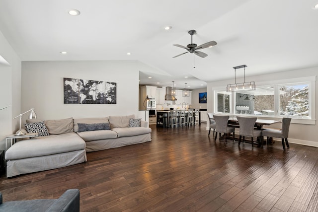 living room with dark wood-type flooring, baseboards, ceiling fan, vaulted ceiling, and recessed lighting