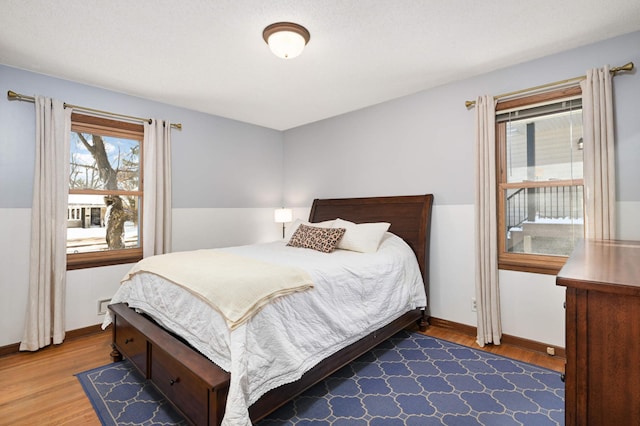 bedroom with baseboards and wood finished floors