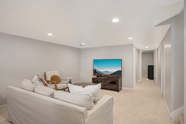 living area featuring recessed lighting, light carpet, and baseboards