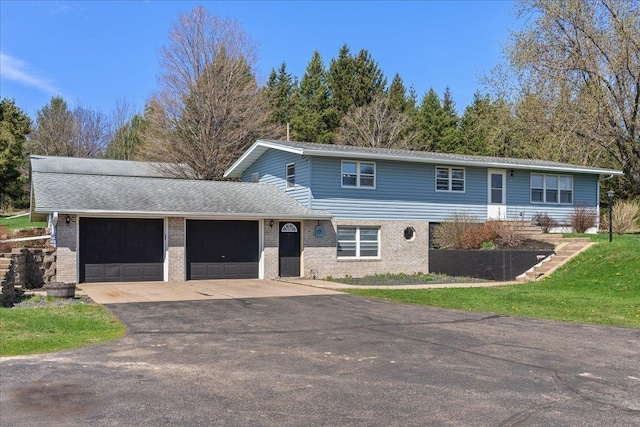 view of front of house with brick siding, aphalt driveway, and a garage