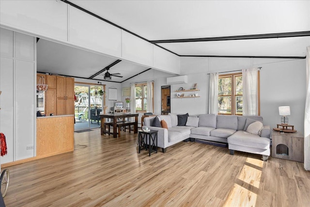living room featuring ceiling fan, a wall unit AC, vaulted ceiling with beams, and light wood-style flooring
