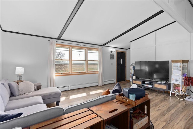 living area with a baseboard heating unit, vaulted ceiling, and light wood-style flooring