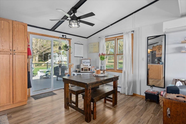 dining room featuring an AC wall unit, a ceiling fan, vaulted ceiling, and light wood finished floors