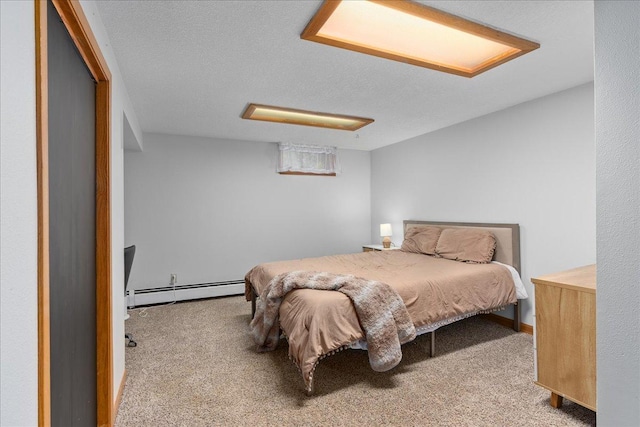 bedroom with carpet floors and a baseboard heating unit