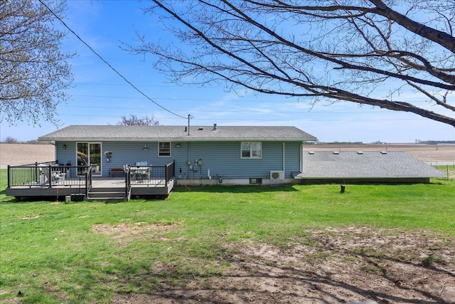 back of house featuring a lawn and a deck