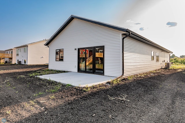 rear view of house featuring a patio and central air condition unit