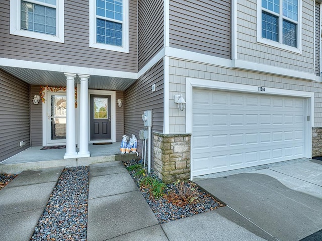 view of exterior entry with a garage