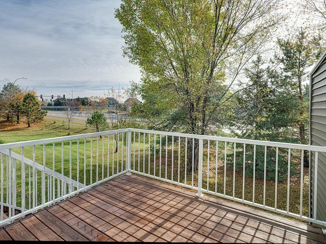 wooden terrace featuring a yard