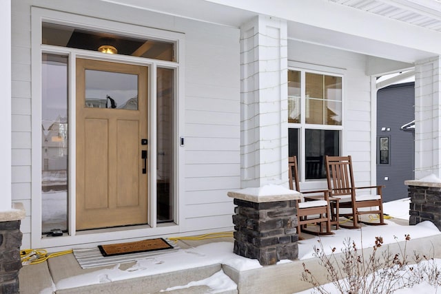 view of snow covered property entrance