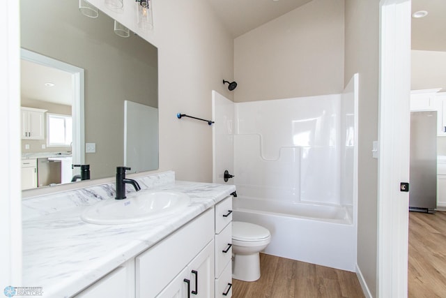 full bathroom with vanity, hardwood / wood-style floors, toilet, and shower / bath combination