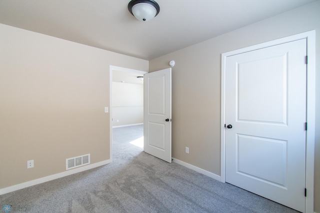 unfurnished bedroom featuring light carpet