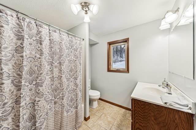 bathroom featuring vanity, toilet, and a textured ceiling