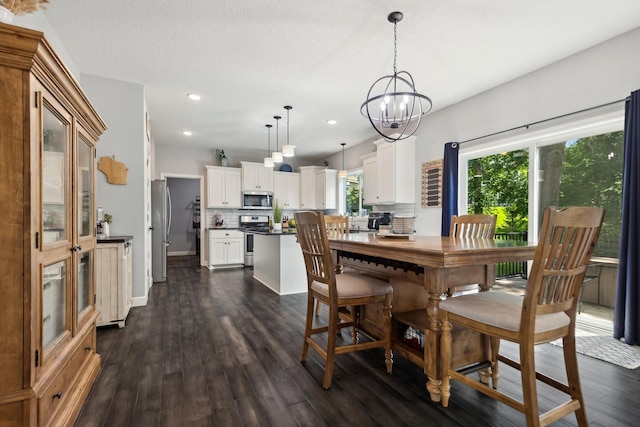 dining space featuring dark wood-type flooring and an inviting chandelier