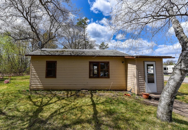 rear view of house featuring a lawn