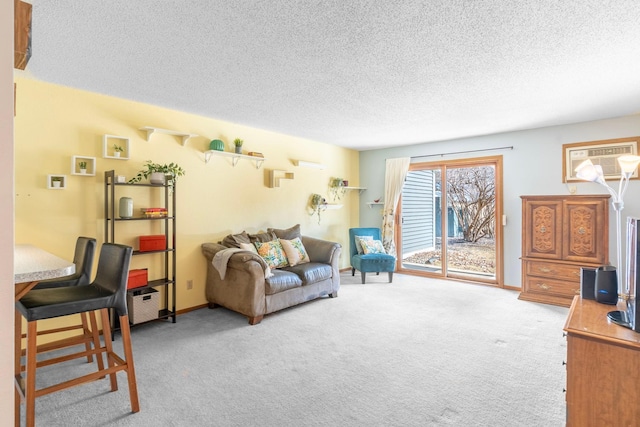 carpeted living area with baseboards, a textured ceiling, a wall mounted AC, and a wall unit AC