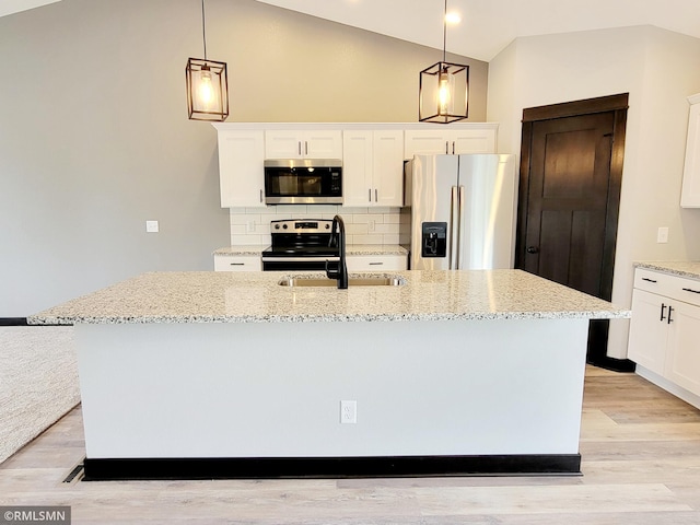 kitchen featuring stainless steel appliances, sink, hanging light fixtures, and a center island with sink