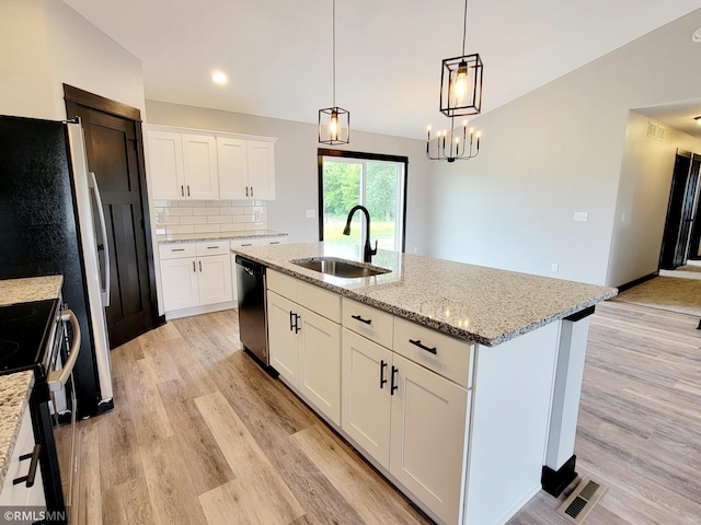 kitchen featuring sink, white cabinetry, decorative light fixtures, a center island with sink, and stainless steel appliances